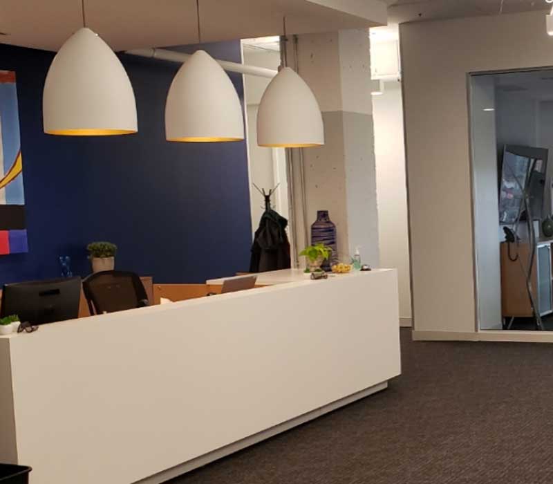 sra law office front desk with three white lights hanging above